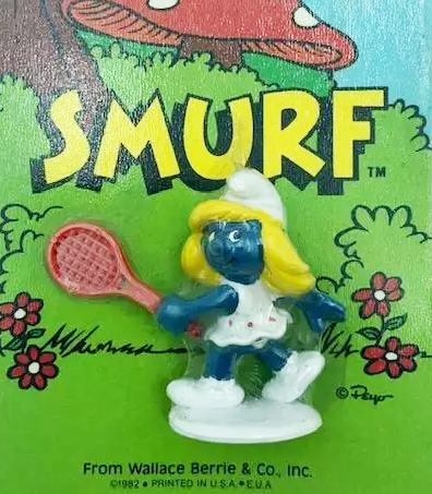 Vintage Smurf figurines arranged in front of mushroom houses